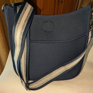 Neoprene lightweight perforated crossbody bag.